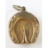 Victorian Lucky Horseshoe Hinged Locket, the unmarked 15 gold decorated with chased foliate work,