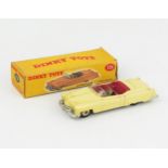 A Dinky Toys 131 Cadillac Tourer in yellow with cerise interior, grey driver and cream hubs in