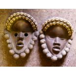 Two African masks with cowrie shell decoration
