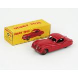A Dinky Toys 157 Jaguar XK120 Coupe in red with red hubs in correct type 1 red spot box showing