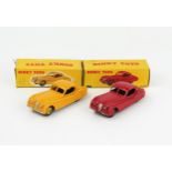 Two Dinky Toys 157 Jaguar XK120 Coupes one in yellow with light yellow hubs, one in red with red