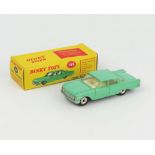 A Dinky Toys 148 Ford Fairlane in pea green with cream interior, closed windows and spun hubs.