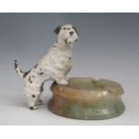 An Art Deco soapstone ashtray with painted scotty dog standing on the rim, 13cm high.