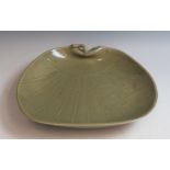 A dark green Celadon plate in the form of a Uchwia Japanese fan, incised decoration of clouds, 29.