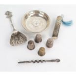 Sewing interest: three silver thimbles, a plated thimble, a plated needle case, an Egyptian pin