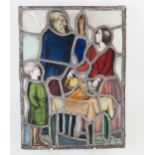 An Arts and Crafts stain glass and lead panel, of rectangular form figures, 36.5x27cm.
