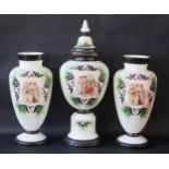 A late Victorian glass garniture, comprising of a lidded vase and a pair of vases, painted cartouche