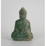 A carved hardstone amulet of the Buddha, seated in the lotus position, 6cm high.