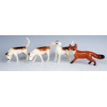 Beswick figures, three Foxhounds and a standing fox, (4).