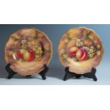 Royal Worcester, a pair of fruit decorated plates, one decorated with peaches and grapes, the