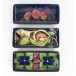 Three modern Moorcroft pin trays of rectangular form, 9x20cm, (3).