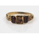 A Georgian Foil Backed Garnet and Citrine? Three Stone Ring in an unmarked high carat gold setting