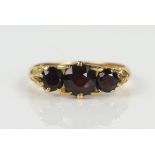 18ct Gold and Garnet Three Stone Ring, marks rubbed, size K.5, 2.9g