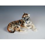 A 20th Century porcelain model of a Tiger, red USSR mark, 27cm long.