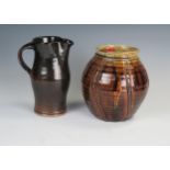 A Keith Smith (born 1946),Studio Pottery, brown glazed jug, 20cm high, together with a ribbed jar/