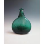 An 18th Century Persian glass saddle flask, heavy blown dark green soda glass bottle, flatten oval