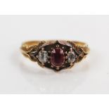 Antique Ruby and Old Cut Diamond Ring in an unmarked high carat gold setting with foliate shoulders,