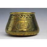 An Indian Islamic brass pot with pierced rim, scripted engraving, 7x8cm.