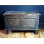 A late 17th Century oak coffer, the two plank lid with cleated end, one wire hinge or replaced,