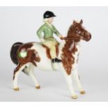 Beswick, a Huntsman, three hounds and girl riding a brown and white piebald pony, (5).
