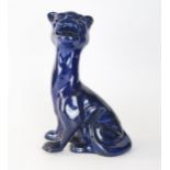 An early 20th Century pottery model of Felix the Cat, thick dark blue glaze on a red pottery body,
