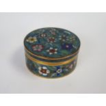A Chinese cloisonnÃ© box, of circular form with pull off lid, gilt metal, turquoise ground, floral