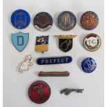 A collection of enamel badges to include: two 1960's Butlins badges, a Jaguar badge and 12 others.