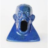 A rare C. H. Brannam Barum hat pin stand, a man with a open mouth and holes in his balled head, dark