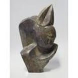 Brighton Sango (1958-1995), abstract sculpture of a fawn, serpentine stone, 38cm.