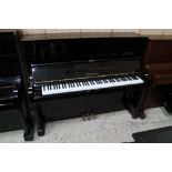Yamaha (c1983) A Model U1 upright piano in a bright ebonised case.