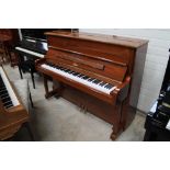 Boston (c2008) A Model 118 upright piano in a bright walnut case. There is VAT on this Lot.
