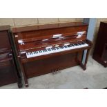 Kemble (c1996) An upright piano in a traditional bright mahogany case; together with a stool.