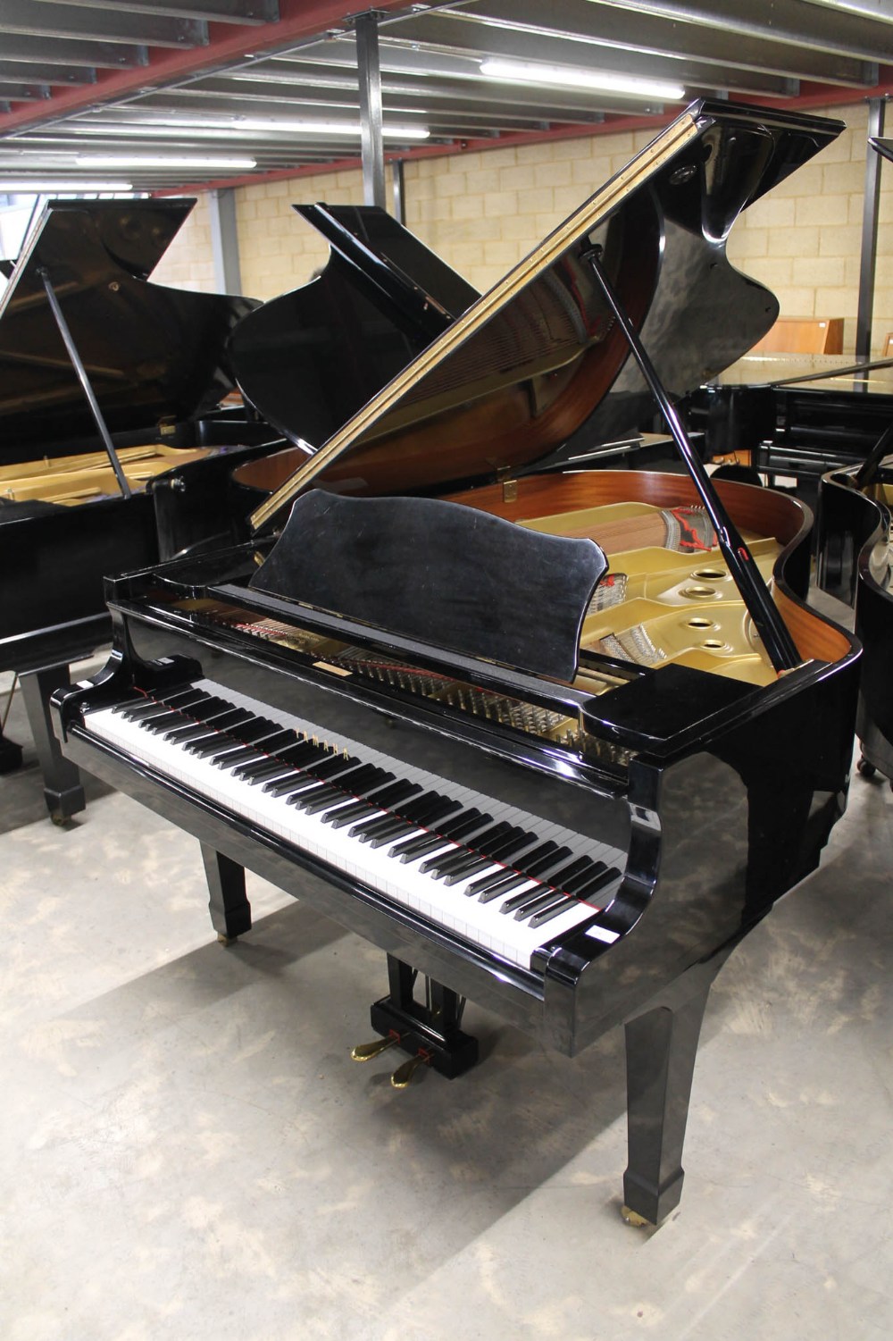 Yamaha (c1980) A 6ft 1in Model C3 grand piano in a bright ebonised case on square tapered legs.