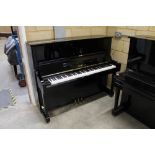 Yamaha (c1971) A Model U1-G upright piano in a bright ebonised case.There is VAT on this Lot.