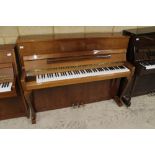 Schimmel (c1985) A Model 112 upright piano in a bright walnut case with cabriole front supports;