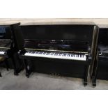 Fukuyama (c1960s) An upright piano in a traditional ebonised case; together with an ebonised