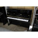 Yamaha (c2007) A Model T118PE upright piano in a traditional bright ebonised case; together with a