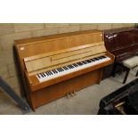 Kawai (c1985) A Model CE7N upright piano in a modern style satin oak case. There is VAT on this Lot.