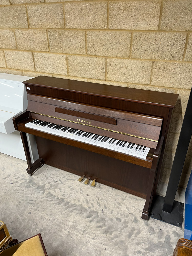 Yamaha (c2001) A Model P110N upright piano in a satin mahogany case; together with a stool.