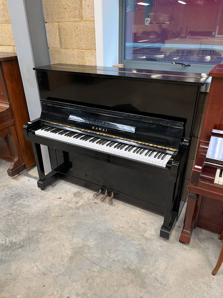 Kawai (c1969) A 124cm upright piano in a bright ebonised case; together with a stool.