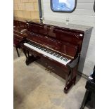 Samick A recent 121cm Model SU121F upright piano in a traditional bright walnut case.