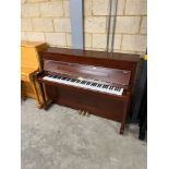 Kemble (c2000) An upright piano in a traditional satin mahogany case; together with a stool.