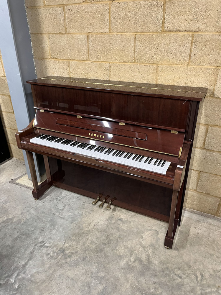 Yamaha (c1998) A Model U1 upright piano in a traditional bright mahogany case.