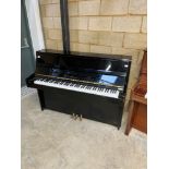 Kawai (c1983) A Model CE-7N upright piano in a bright ebonised case.
