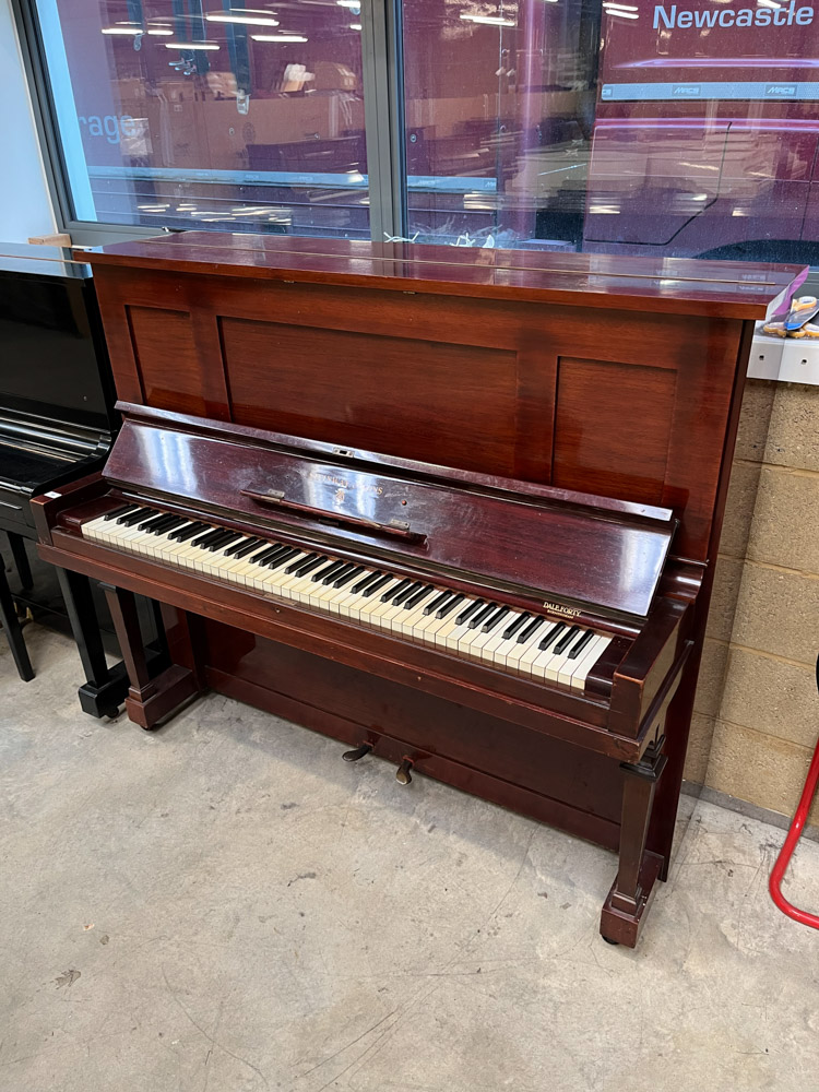 Steinway (c1921) A Model K upright piano in a mahogany case; together with a duet stool.