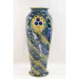A Royal Doulton stoneware vase, with slip trailed decoration to a mottled green ground,