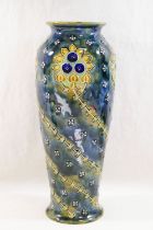 A Royal Doulton stoneware vase, with slip trailed decoration to a mottled green ground,