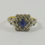 A yellow metal sapphire and diamond rectangular cluster ring,