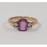 A pink sapphire and clear stone ring,