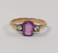 A pink sapphire and clear stone ring,